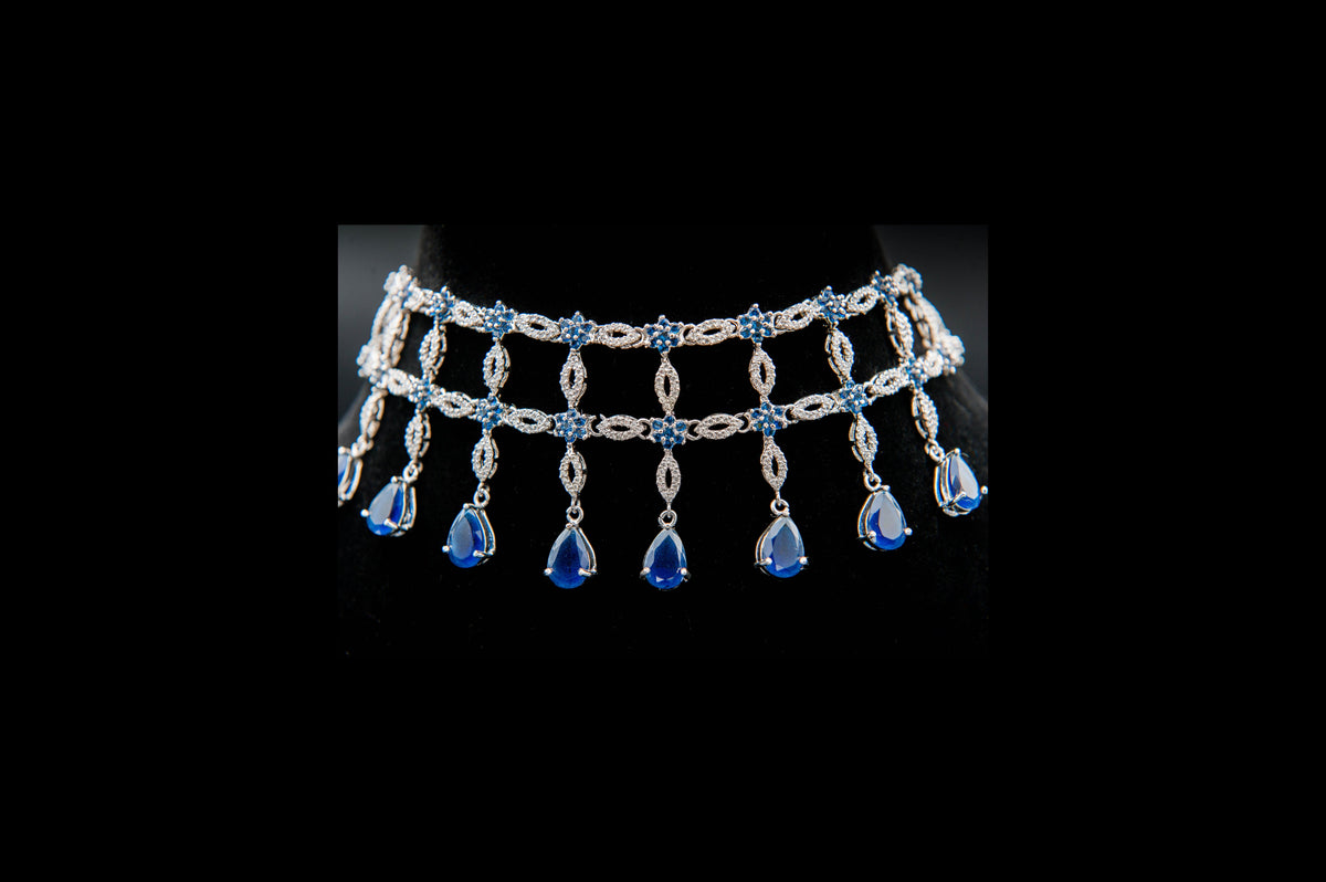 Silver necklace with blue gemstones on a black background