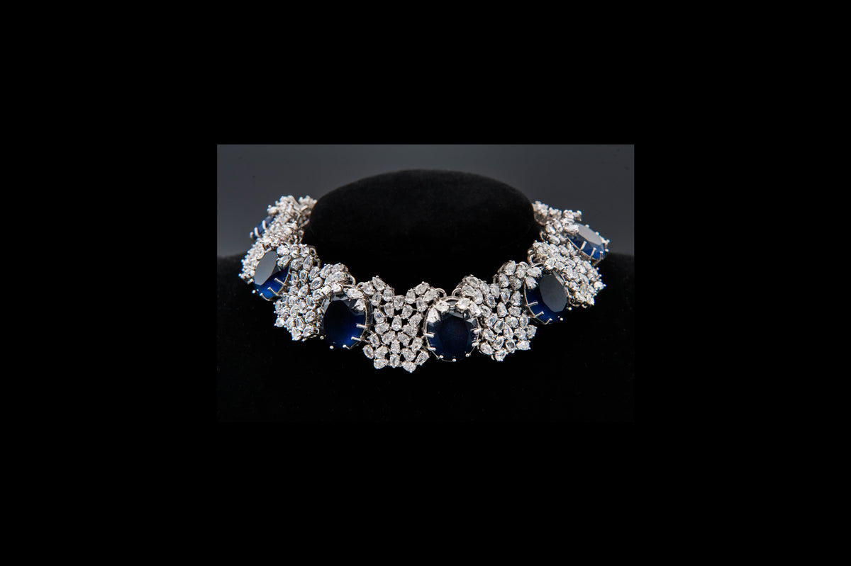 Diamond and sapphire bracelet on a black stand
