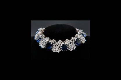 Diamond and sapphire bracelet on a black stand