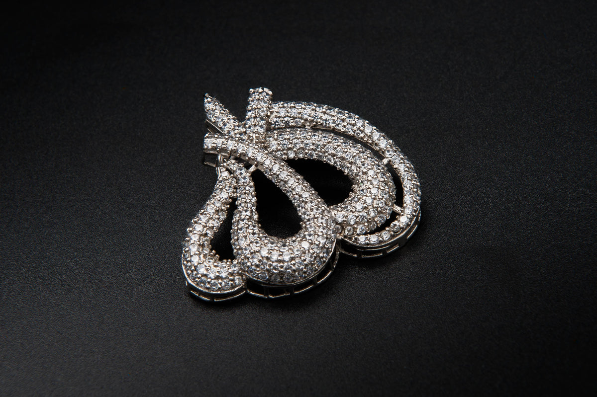 Silver jewelry piece on a black background