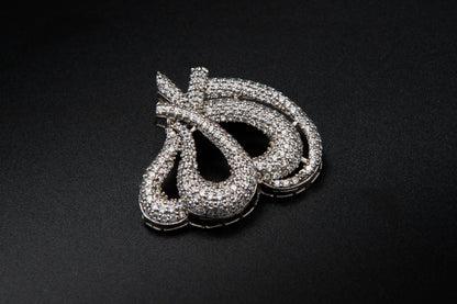 Silver jewelry piece on a black background