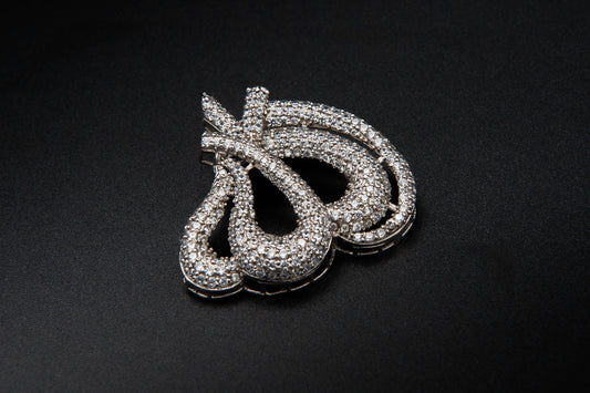 Silver jewelry piece on a black background
