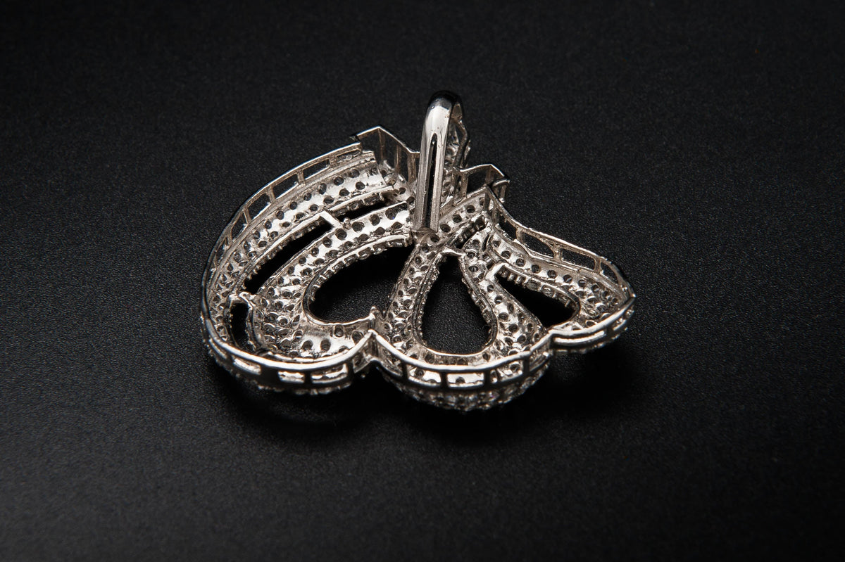Silver necklace pendant on a black background