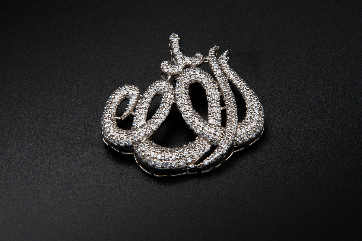 Silver 'Allah' pendant on a black background