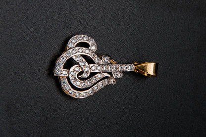 Diamond-encrusted key-shaped pendant on a black background