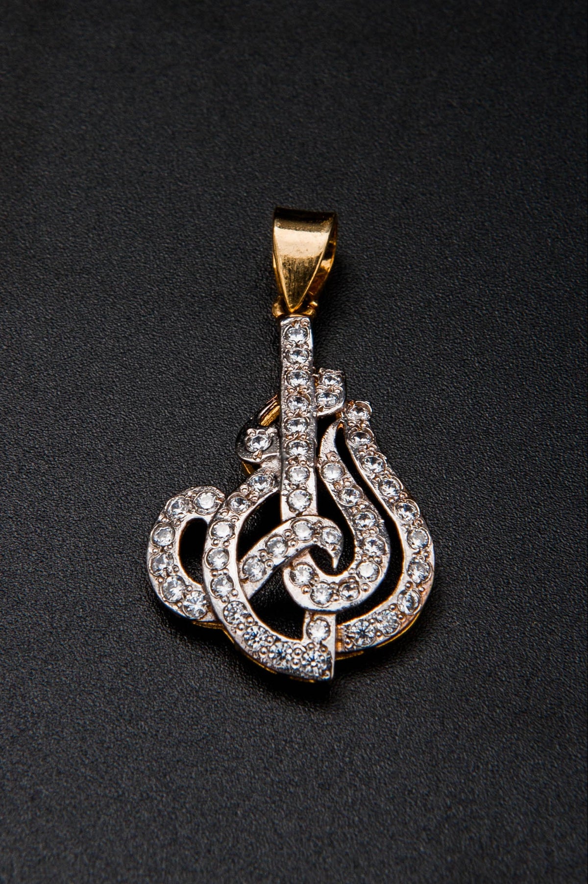 Gold and diamond pendant on a black background
