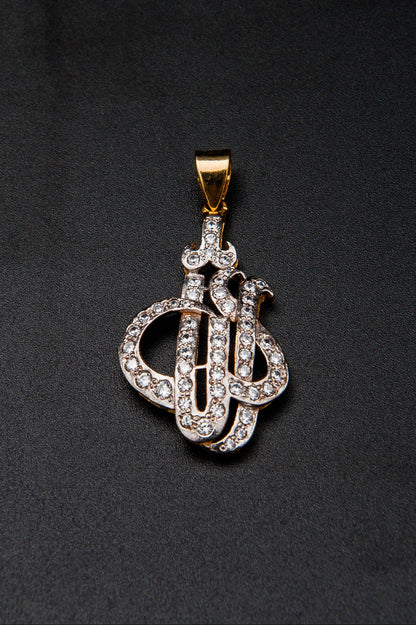 Diamond-encrusted key-shaped pendant on a black background