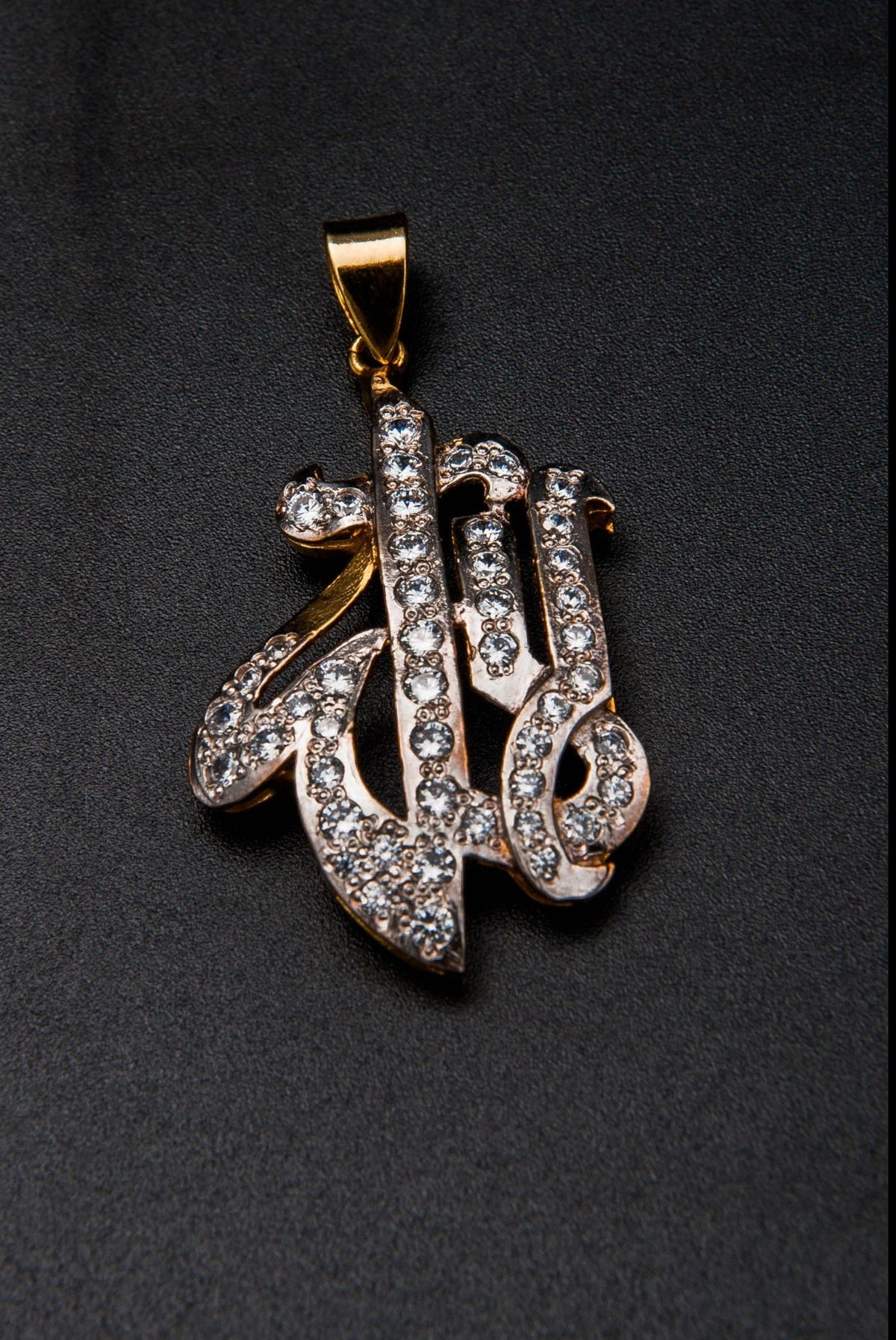 Gold and diamond pendant on a black background