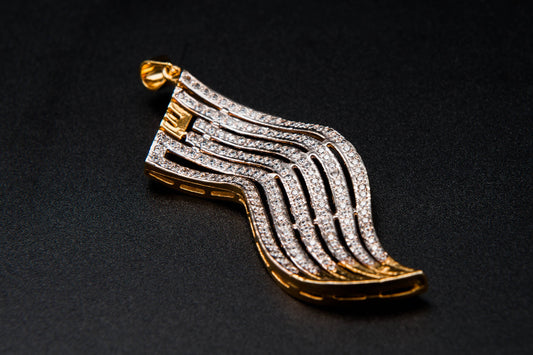 Gold and diamond shoe brooch on a black background