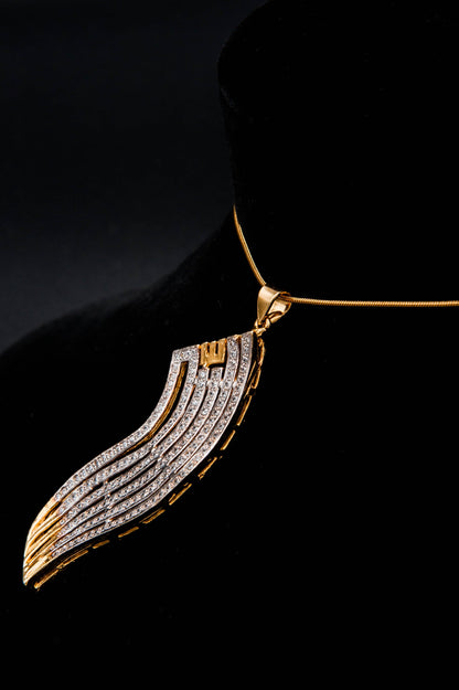 Gold and silver wing-shaped pendant on a black background