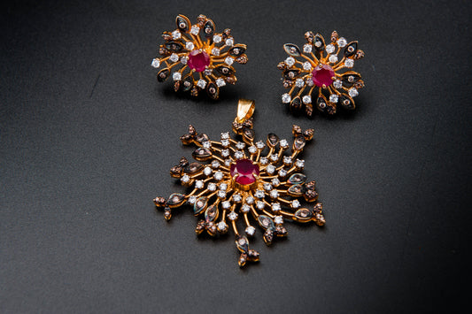 Gold jewelry set with red gemstones on a dark background