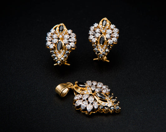 Gold and diamond earring set on a black background