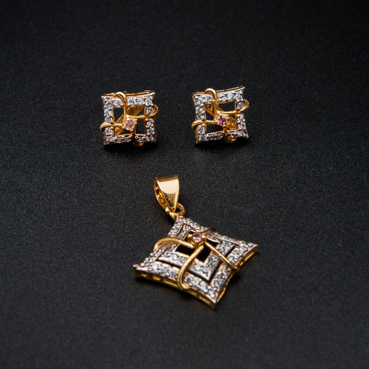 Gold jewelry set with earrings and a pendant on a black background