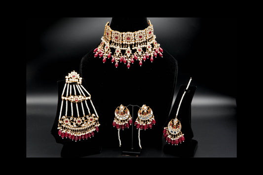 Jewelry set with necklace, earrings, and bangles on a black background